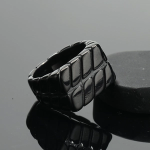 Minimalist black stainless steel men's ring with textured geometric leaf pattern design