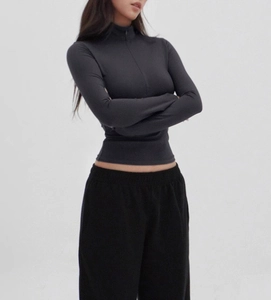Close-up of slim fit grey sports top with V-neck zipper and premium elastic fabric