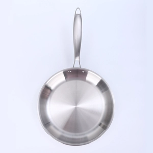 Detail of 3-ply stainless steel frying pan with brushed texture and ergonomic handle