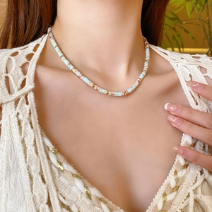 Detail of round Shoushan stone necklace featuring light blue and beige beaded texture