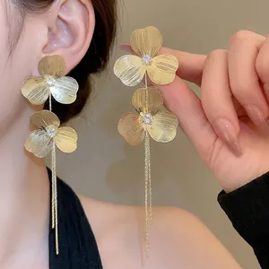 Elegant gold flower tassel earrings with zircons and brushed metallic finish for women