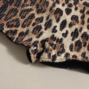 Macro shot of sequined leopard print fabric with precise edge stitching and inner lining