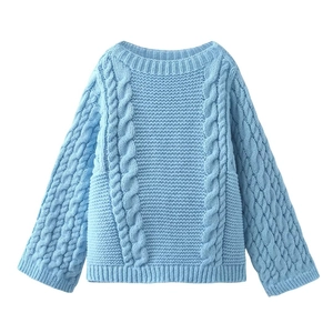 Close-up of the sky blue cable knit sweater detailing the thick textured stitch pattern