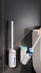Wall-mounted disposable toilet brush with blue sponge head and white storage holder