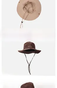 Détail d'un chapeau de soleil avec aérations et broderie de montagne sur tissu café