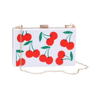 White acrylic evening clutch bag with cherry print and golden chain strap