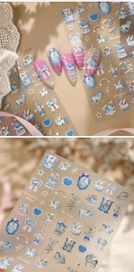 Detail of unicorn and rainbow nail stickers with blue and white dreamlike fairytale designs