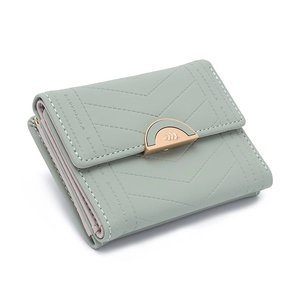 Detail view of mint green tri-fold wallet with V-shaped stitching and metal snap closure