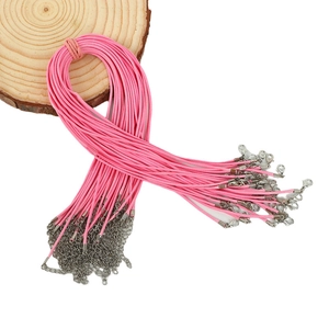 Pink braided necklace cord with silver lobster clasp and extension chain on white background
