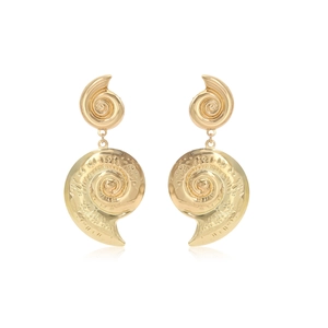Macro detail of gold spiral conch shell earrings with textured metallic finish