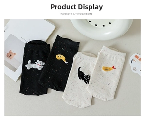 Detailed view of four colorful confetti knit socks with cute embroidered animal patterns