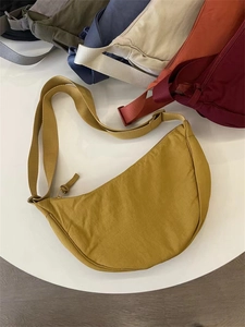 Detailed top view of nylon crescent bags in various colors with adjustable wide straps