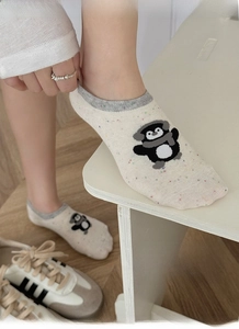 Close-up of cream low cut sock with cute penguin pattern and high elasticity knit fabric