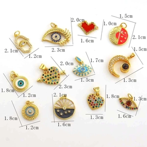 Flat lay view of various copper pendants with size measurements and evil eye designs