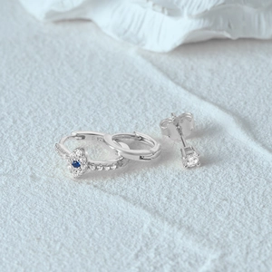 Detailed view of S925 sterling silver evil eye earrings set with blue crystal inlays