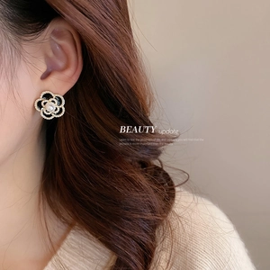 French retro camellia stud earrings with black enamel petals and center pearl detail