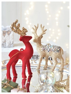 Detail of red flocked reindeer and golden glitter sequins Christmas ornaments on tray