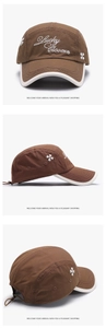 Détail de la casquette marron avec broderie Lucky Clover et cordon de serrage réglable