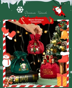 Close-up of velvet Christmas gift bags with festive embroidery and satin drawstrings