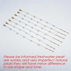 Detail of multiple freshwater pearl bracelets with gold chains and lobster clasps