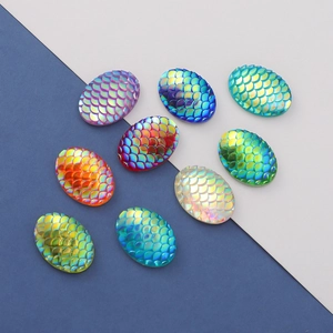 Detail view of 13x18mm oval resin cabochons with rainbow fish scale pattern for DIY