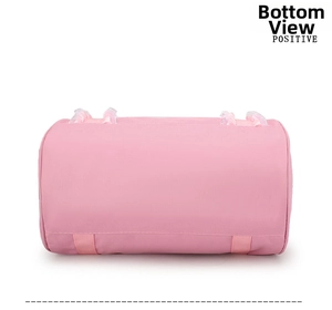 Detailed bottom view of pink cylinder dance bag with reinforced straps and lace trim