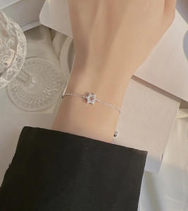 Detailed view of hollow star charm bracelet with sparkling pavé stones and adjustable chain