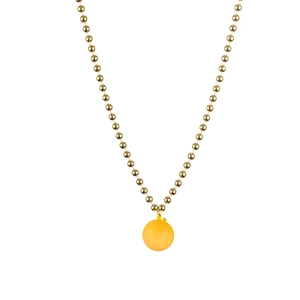 Close-up of golden bead chain necklace with glowing yellow disco ball pendant
