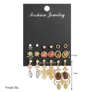 Detailed view of 6 pairs earring set featuring pearls and studs on black card