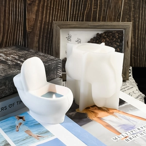 Detail of toilet shaped silicone mold with finished candle in a creative desktop setting