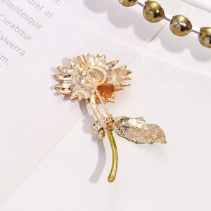 Detailed back view of golden sunflower brooch showing safety pin and enamel finish