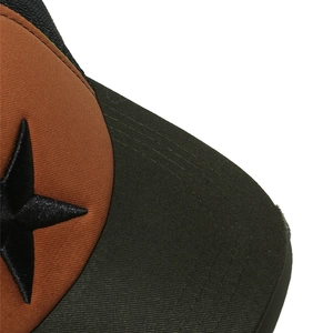 Detailed close-up of 3D star embroidery on orange and olive mesh trucker cap
