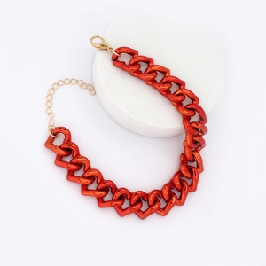 Macro detail of orange heart link chain pet necklace with adjustable gold metal clasp