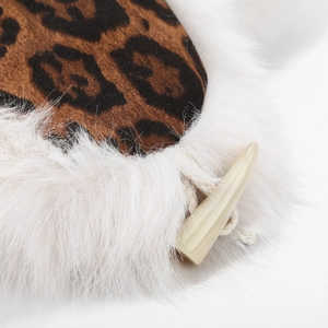 Winter leopard print trapper hat with white faux fur lining and horn button closure