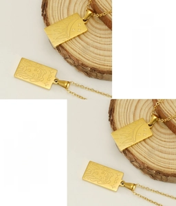 Detail of 18K gold plated tarot necklaces showing celestial relief on stainless steel