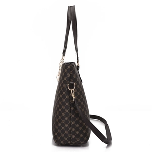 Side view of printed tote bag showing textured material and metallic golden buckle