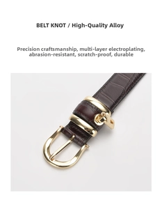 Detail of premium alloy gold buckle on dark brown crocodile pattern leather belt