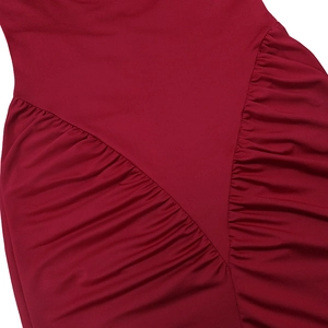 Detailed view of red ruched fabric texture and stitching on a slim-fit bodycon dress