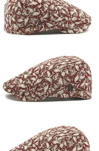 Detail of vintage beret hat featuring bronze adjustable buckle and floral jacquard fabric