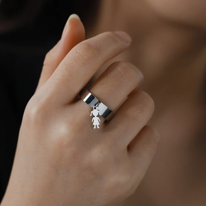 Polished stainless steel ring with a cute girl charm pendant on middle finger