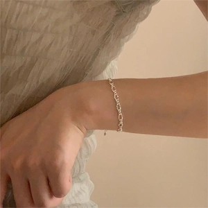 Elegant S925 sterling silver geometric link bracelet worn by a model in warm lighting