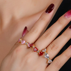 Luxe gold-plated multi-finger ring featuring heart-shaped pink and burgundy gemstones