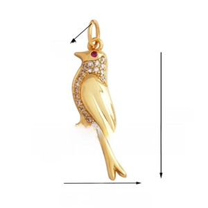 Macro view of gold bird pendant with white cubic zirconia and red eye detail