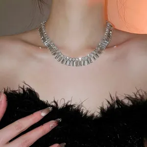 Elegant rhinestone fringe necklace with baguette and round cut crystals in silver finish