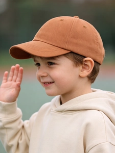 Close-up of caramel cotton twill kids baseball cap with six-panel design and curved brim