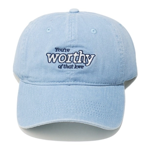 Detail of blue washed cotton baseball cap featuring 3D text embroidery on front crown