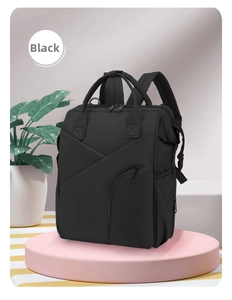 Front detail of black nylon mummy backpack with insulated pockets on pink pedestal