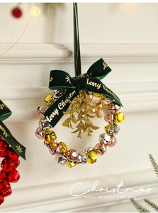 Close-up of a Christmas bell wreath with velvet bow and Merry Christmas gold lettering