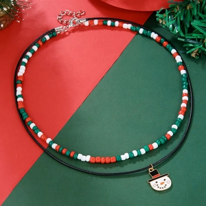 Detailed view of festive double-layer Christmas necklace with snowman pendant and glass beads
