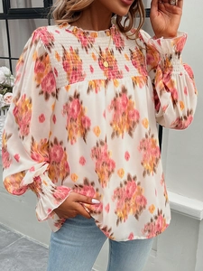Detail of smocked chest and ruffle collar on a floral print long sleeve blouse